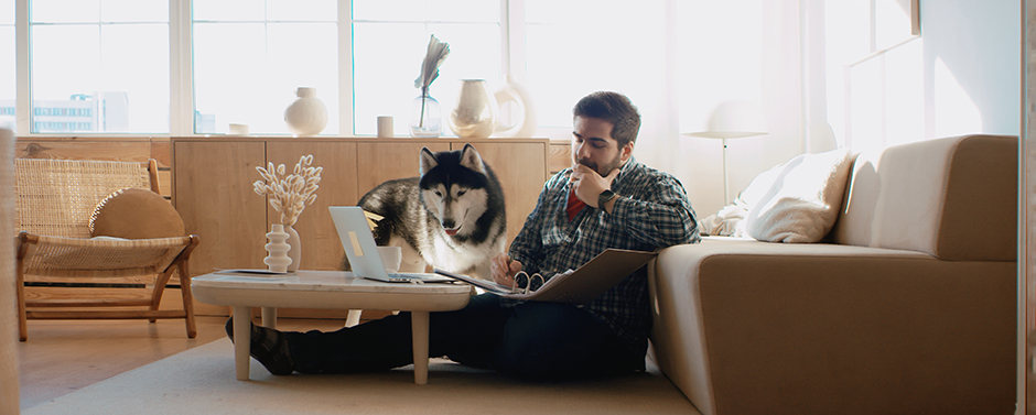Man and is pet dog. Working at home, remote work.